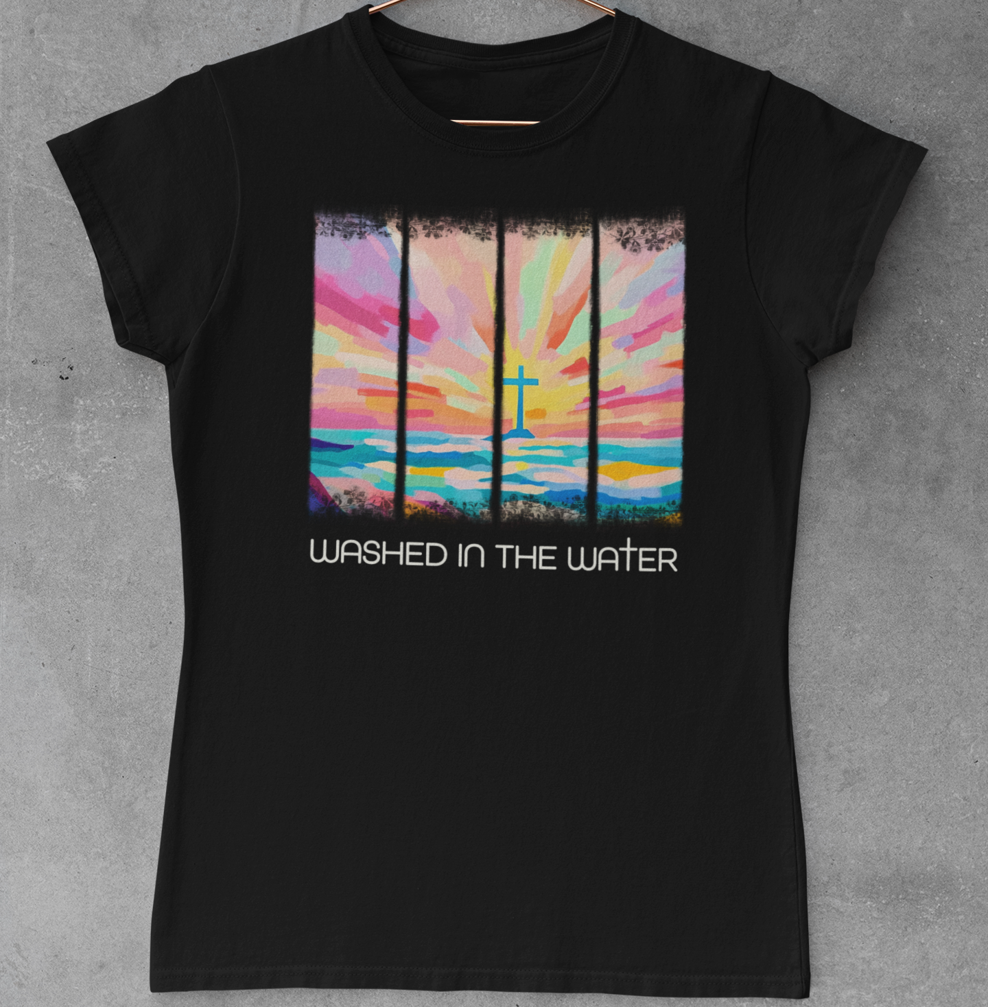 Black t-shirt with a colorful graphic and text 'Washed in the Water' on a gray background