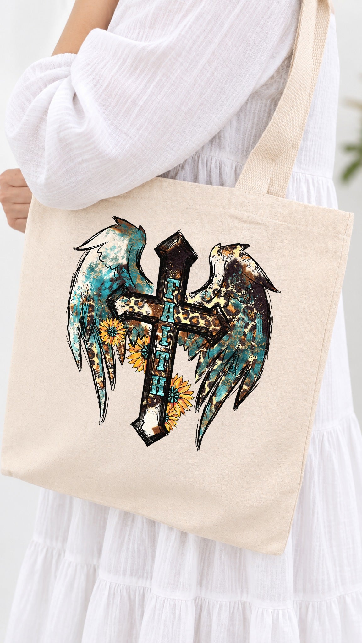 Faith Winged Cross tote bag - carried on the shoulder