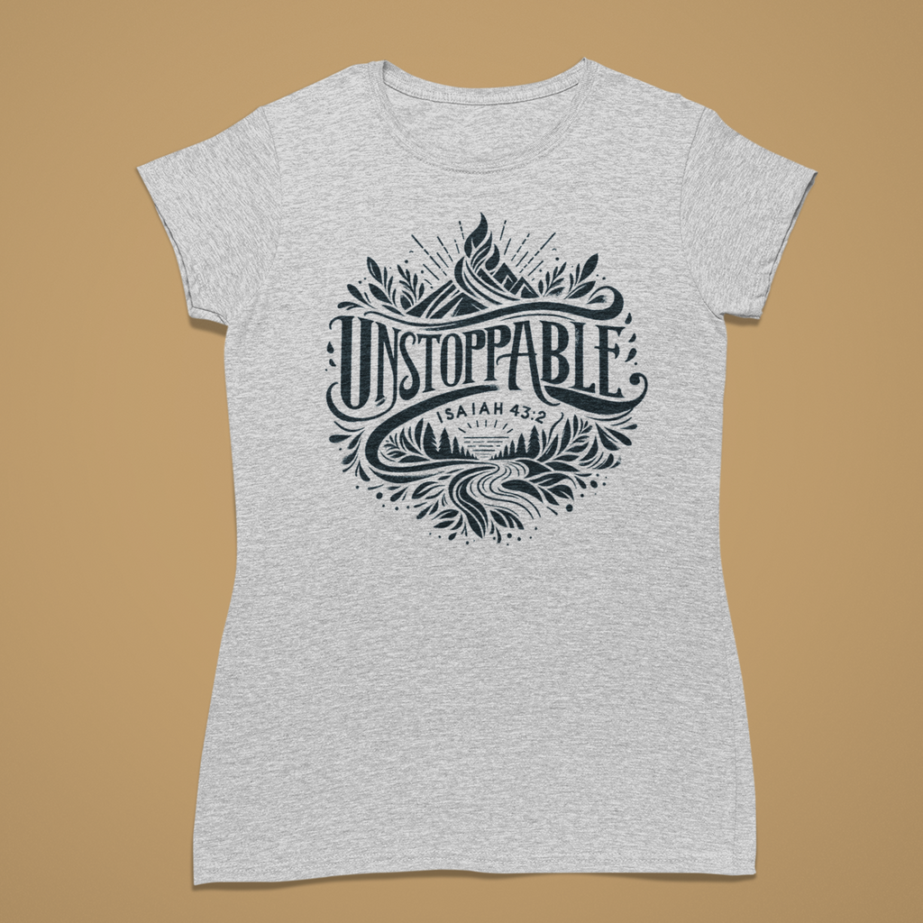 A light heather gray short-sleeve t-shirt with a dark navy graphic print on the front. The graphic features stylized text reading 'UNSTOPPABLE' with 'SAINT JACOB' and '1899' below it, surrounded by mountain and landscape illustrations.